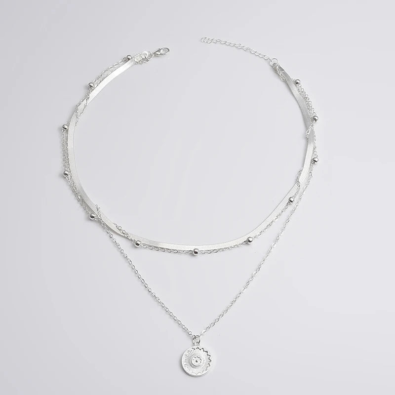 Indulge in our elegant three-layer round necklace made of 925 sterling silver. Featuring a simple snake chain and charm ball chain design