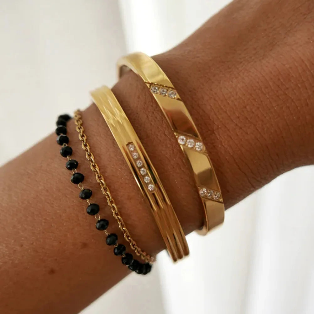 Stylish punk-inspired gold-colored bangles crafted from stainless steel, suitable for both men and women.