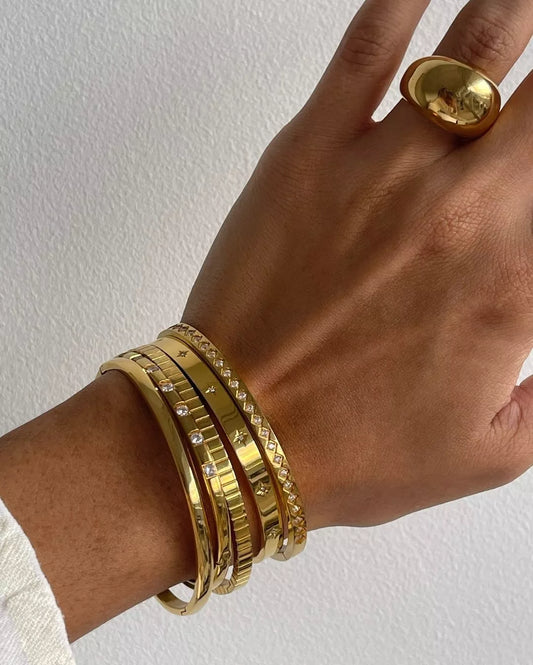 Stylish punk-inspired gold-colored bangles crafted from stainless steel, suitable for both men and women.