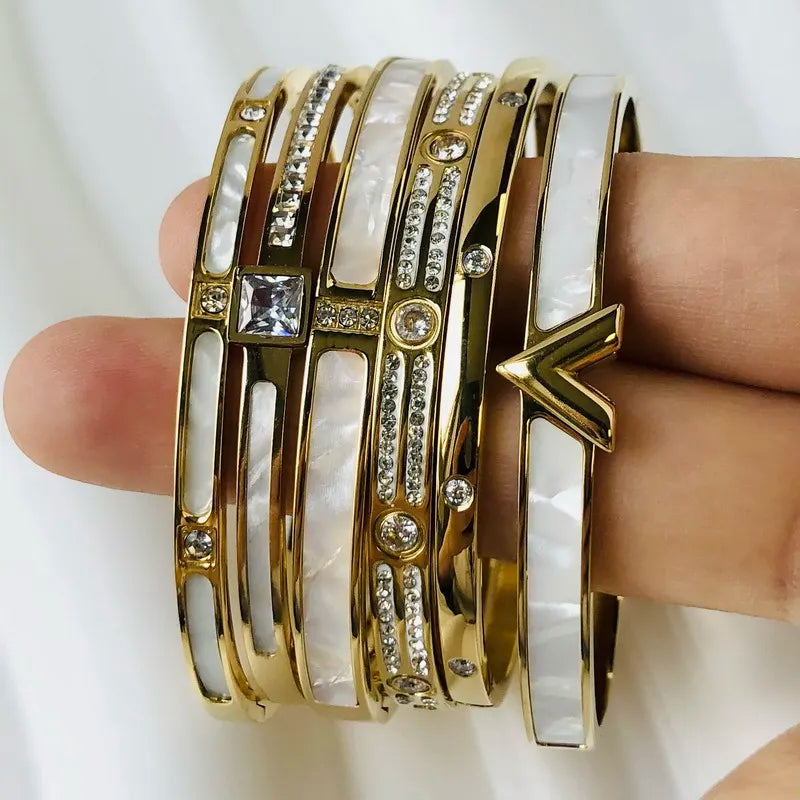 Discover our latest design of bracelets and bangles for women, featuring exquisite zircon inlays. Available in gold and silver colors, these stainless steel pieces are not only waterproof but also epitomize luxury brand jewelry.